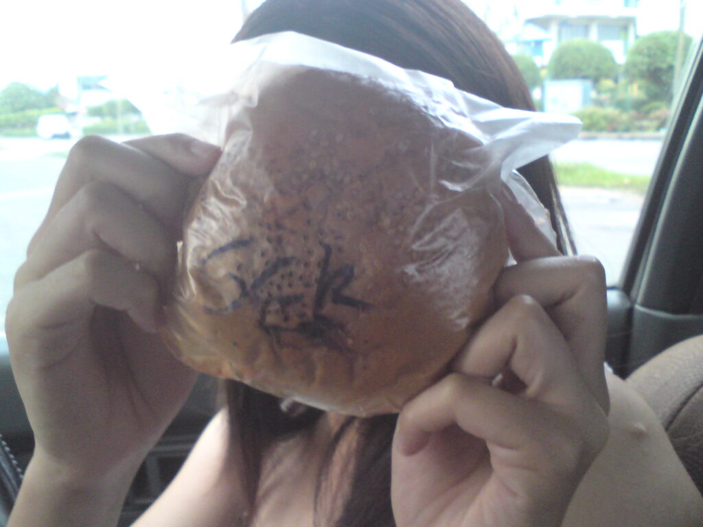 Her face is big, but the burger is bigger