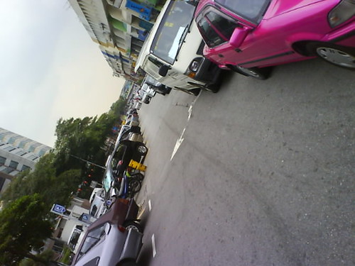 Cars parked around the shop lots near the bank