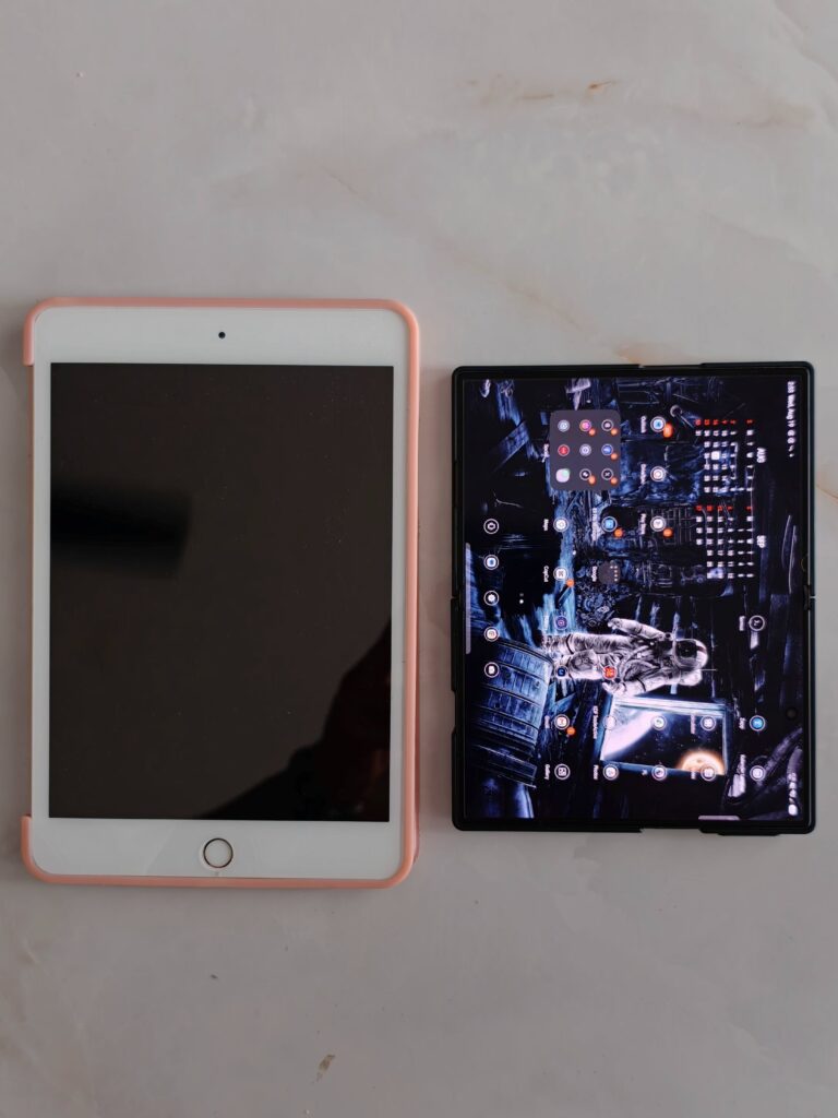 Foldable phone beside an iPad Mini for a screen-size comparison