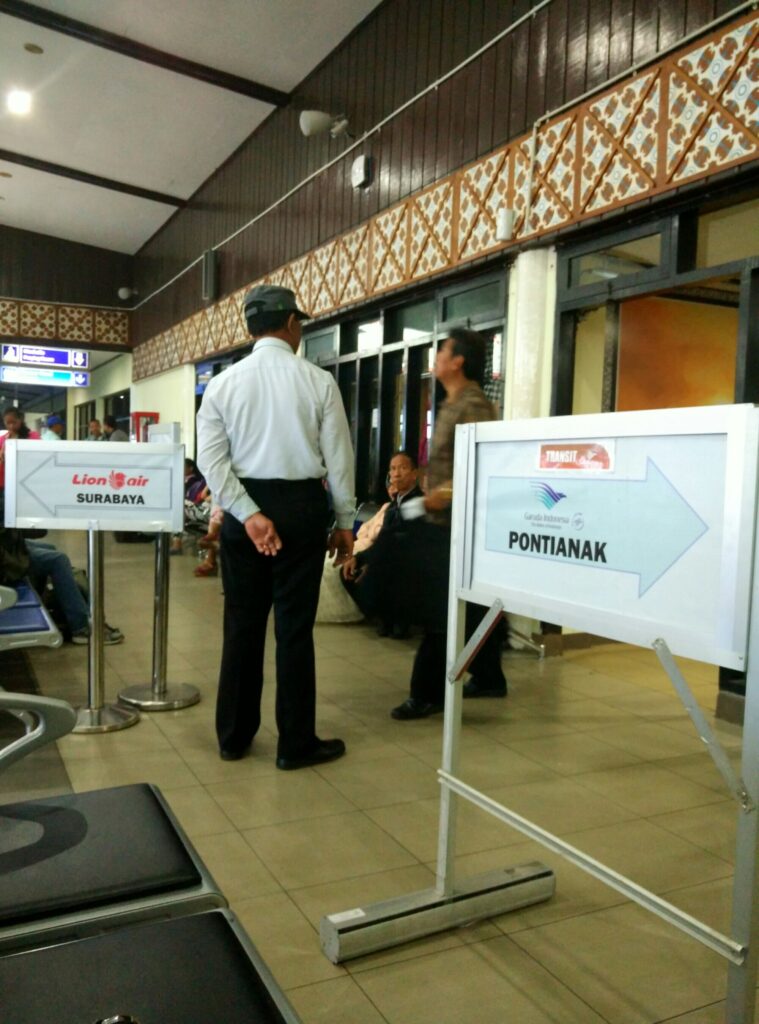 An uncle directing passengers to different sections