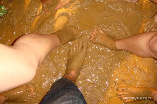 Festival-goers standing in deep mud at Rainforest World Music Festival 2008